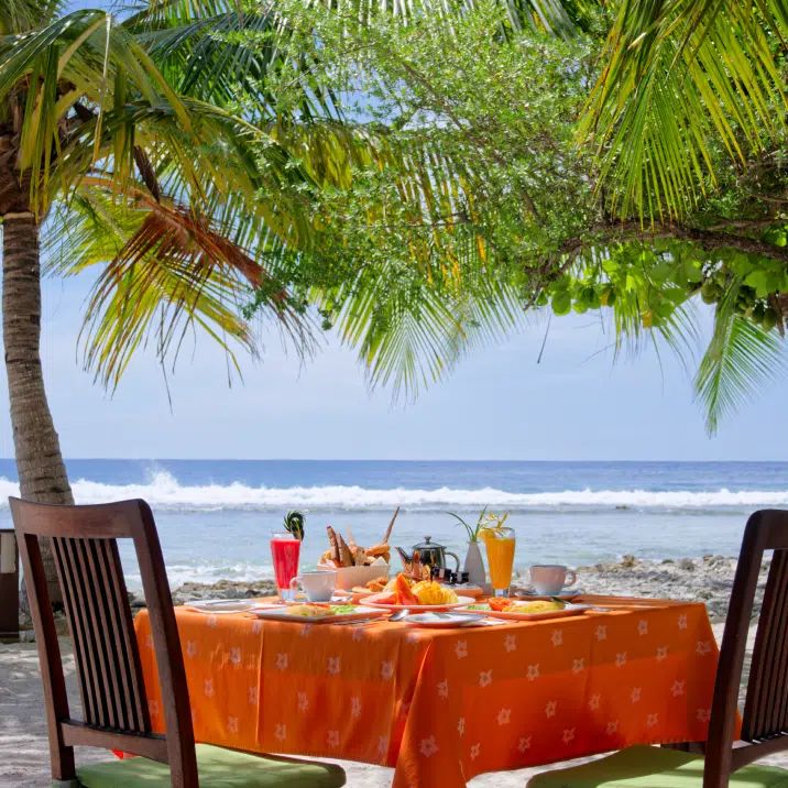 A meal served by the ocean at Canareef Resort Maldives