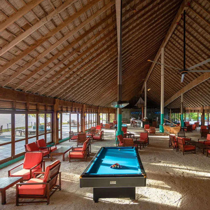 Interior of a restaurant with a pool table at Canareef Resort Maldives
