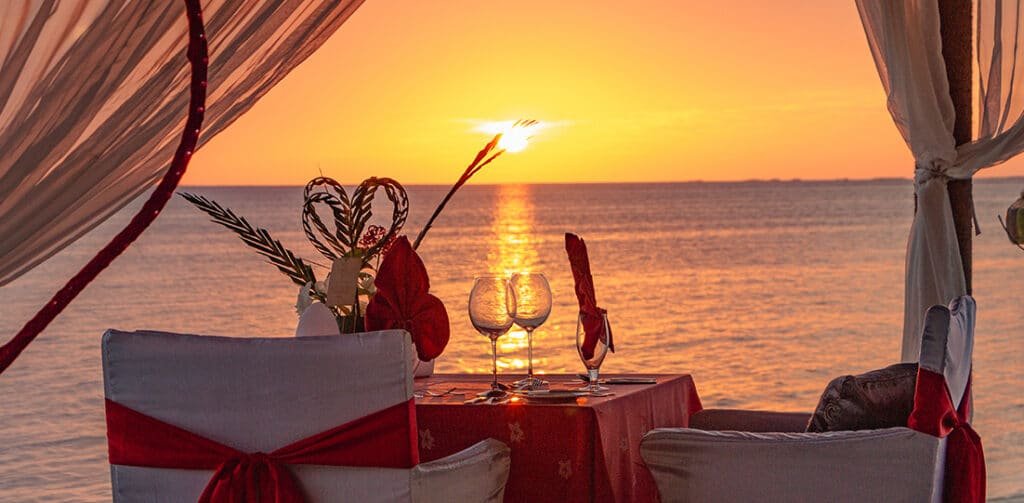A table for two with a sunset in the background
