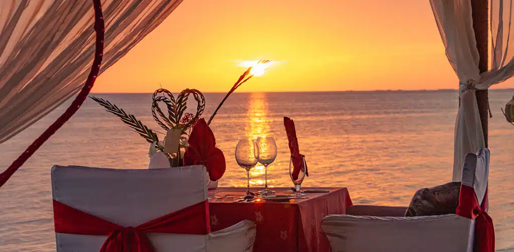 A set-up of a romantic meal at the beach of Canareef Resort