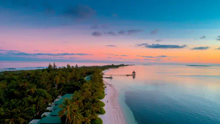 Aerial view of the beach at Canareef Resort Maldives during sunset
