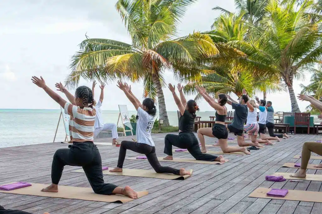 People doing yoga at Canareef Reort Maldives