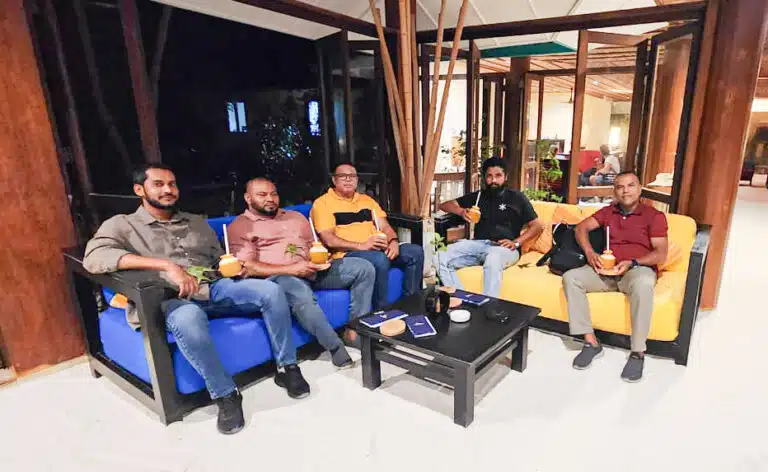 A group of people in the lobby at Canareef Resort Maldives
