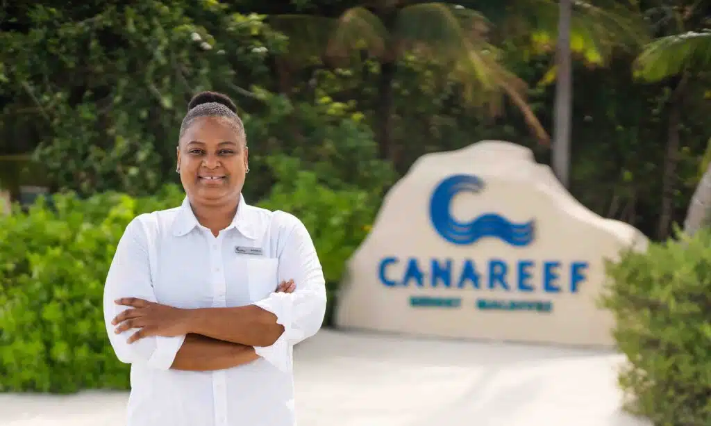 A staff member at the entrance of Canareef Resort Maldives